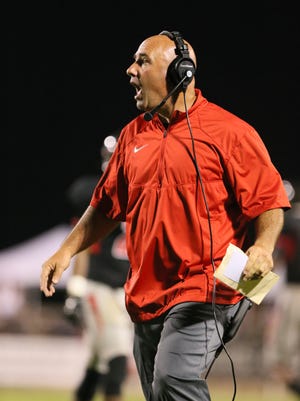 Brandon head football coach Brad Peterson calls a play during Friday's game against Clinton. The Class 6A MHSAA football game was played Friday, September 5, 2014 in Brandon. (Photo by Keith Warren)