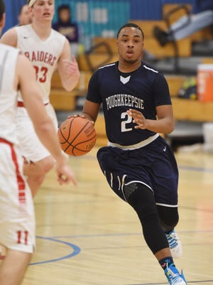 Akili Hill dribbles up court for the Poughkeepsie High School basketball team.
