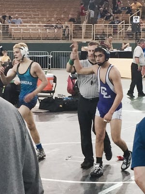 Cypress Lake freshman Jalen Soto has his hand raised after his win in the 120 pound match in Class 2A.