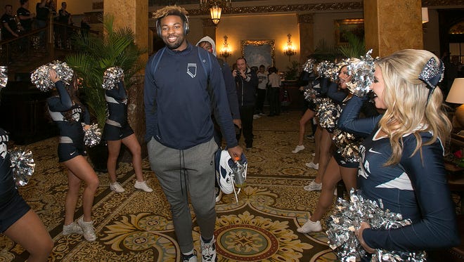 Jordan Caroline walks out of the team hotel during a pep rally before Nevada's game against Iowa State.