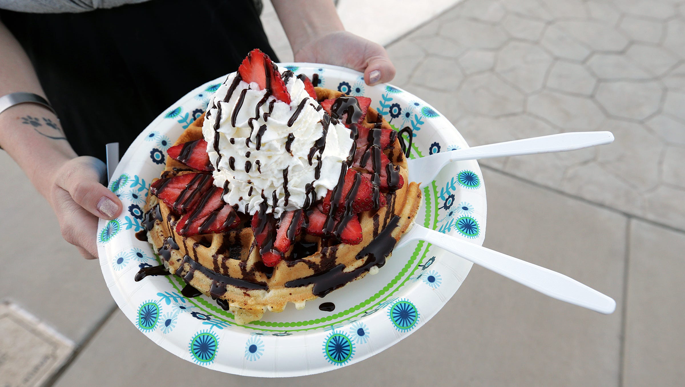 The Blue Collar Shaved Ice food truck serves waffles loaded with strawberries, chocolate sauce, and whipped cream.