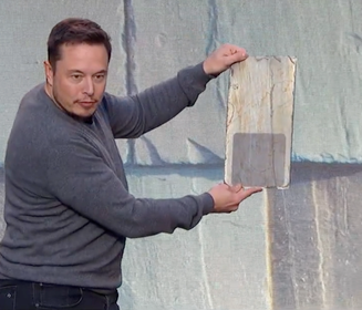 Tesla CEO Elon Musk shows a Tesla solar roof cell.