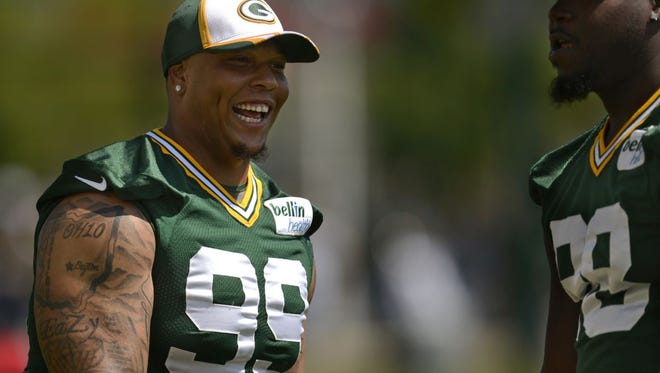 Green Bay Packers defensive end Jerel Worthy (99) jokes around with teammate Letroy Guion during training camp practice at Ray Nitschke Field on Tuesday, Aug. 5, 2014.
