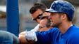 Feb. 19: Tim Tebow  looks on from the batting cage,