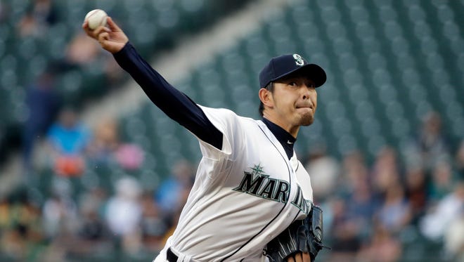 Seattle Mariners starting pitcher Hisashi Iwakuma throws against the Houston Astros in a baseball game Monday, April 20, 2015, in Seattle.