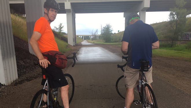 Mark and I take shelter from the rain under a freeway overpass on the Chippewa River State Trail.
