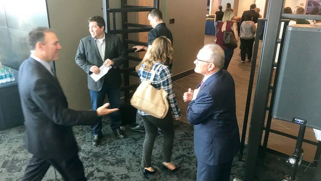 Milwaukee Bucks president Peter Feigin (second from left) and Kevin Steiner (right), president and CEO of West Bend Mutual Insurance, greet visitors to the West Bend Lofts at the Fiserv Forum.