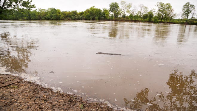 Debris in the Wabash River floats past the boat launch at Mascouten Park Thursday, May 4, 2017, in West Lafayette. Flooding is expected in some areas, but not severe.
