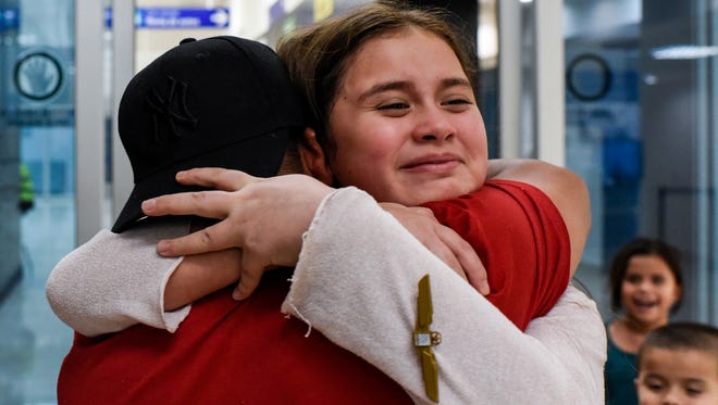 Antonio Cuahua (from left to right) hugs his 10-year-old daughter Cecily Cuahua after she and his three other children, Enrique Cuahua, 5, Marrissiah Cuahua, 6, and Anthony Cuahua, 8, (not pictured) arrived at the Veracruz International Airport in Veracruz, Mexico, Thursday, Jan. 11, 2018. Before reuniting at the airport, he had not seen his children in over three months. 
