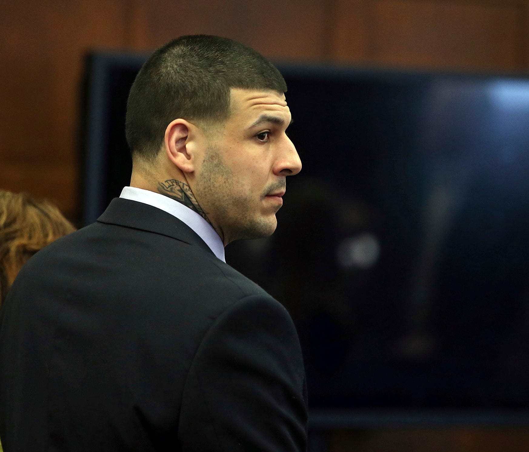 Former New England Patriots tight end Aaron Hernandez stands at the defense table when court is adjourned without a verdict on day five of jury deliberations in his double murder trial at Suffolk Superior Court on Thursday, April 13, 2017.