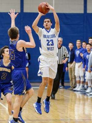 Waukesha West junior Rocky Martinez Jr (23) tries for three during the game at home against Mukwonago on Friday, Jan. 12, 2018.