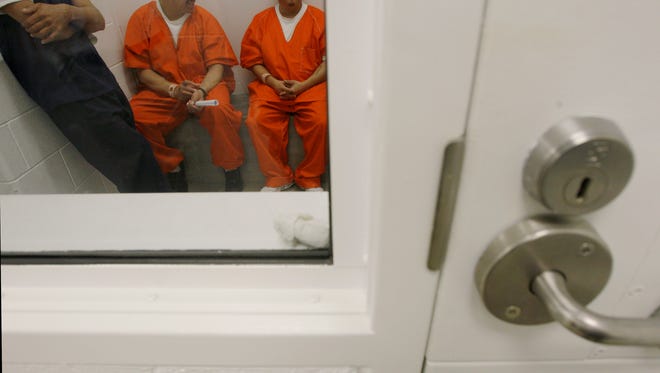 Detainees inside a holding cell at the Northwest Detention Center in Tacoma, Wash. The facility is operated by the GEO Group.