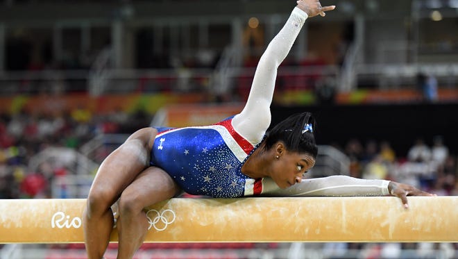 Simone Biles, shown here competing on the beam during the all-around competiton, won the all-around gold by a whopping 2.1 points over U.S. teammate Aly Raisman.