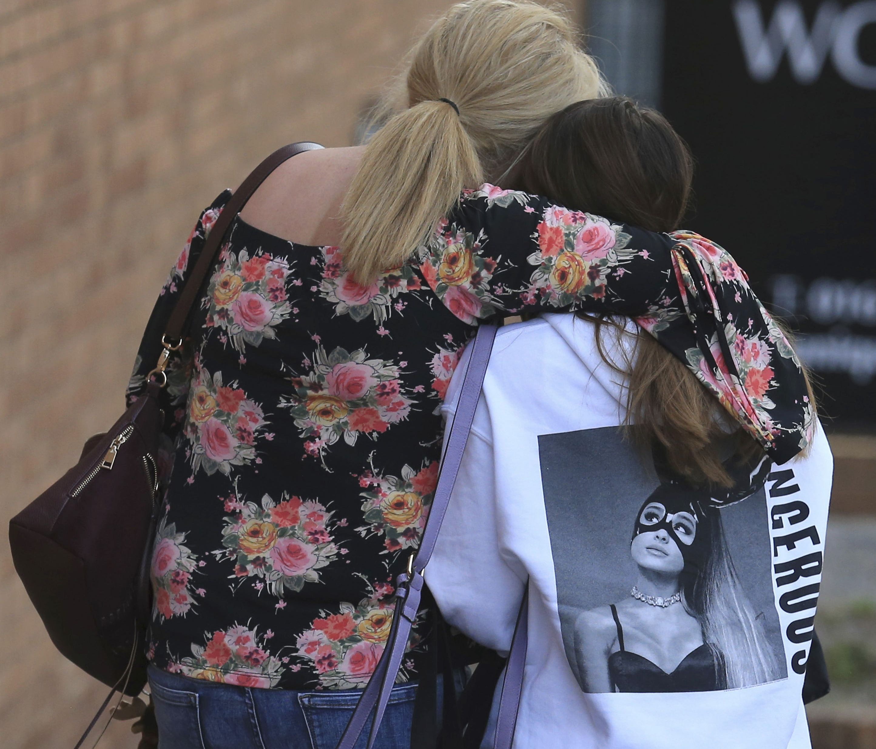 A fan is comforted as she leaves the Park Inn hotel in central Manchester, England May 23.  At least 22 people were killed in an explosion following a Ariana Grande concert at the Manchester Arena late Monday evening. Following the attacks, some on s