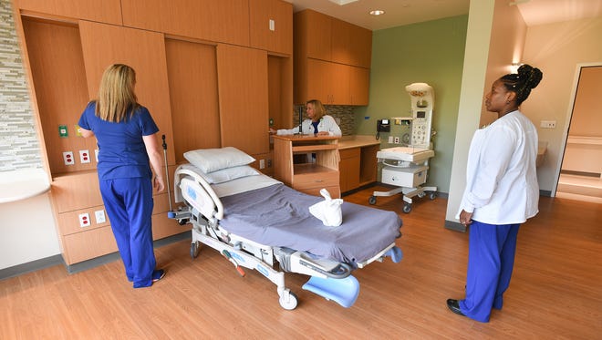 From left, Patewood Memorial Hospital surgery nurses Kelli Fleming, Cheryl Tucker, and Tiffany Simmons get their first look at one of the labor and delivery rooms in the hospital's new maternity unit on Thursday, August 24, 2017.
