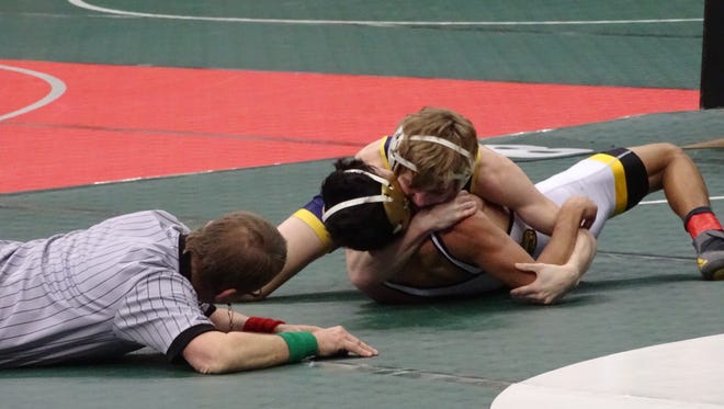 Lancaster sophomore Logan Agin nears a pin of Painesville Riverside's Chris Rocha in a 106-pound match Thursday during the Division I state tournament at Ohio State's Value City Arena.