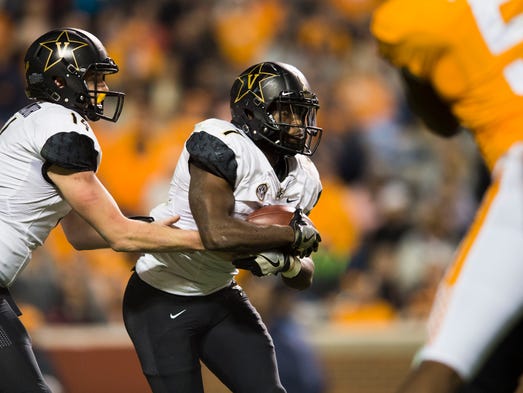 Vanderbilt quarterback Kyle Shurmur (14) hands the
