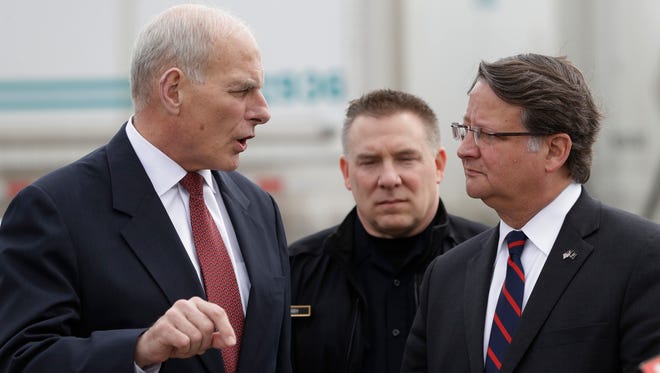 Homeland Security Secretary John Kelly, left, talks with Sen. Gary Peters D-Mich., before a news conference at the Ambassador Bridge border crossing, Monday, March 27, 2017, in Detroit.