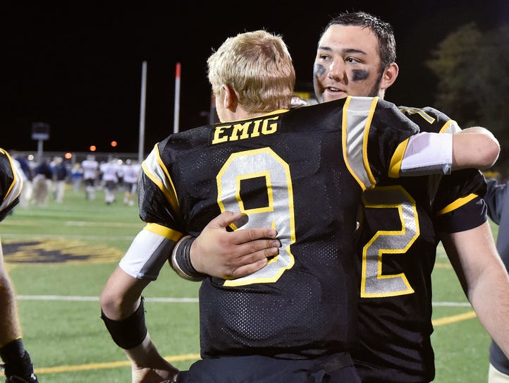 Red Lion quarterback Sam Emig (9) greets fellow captain