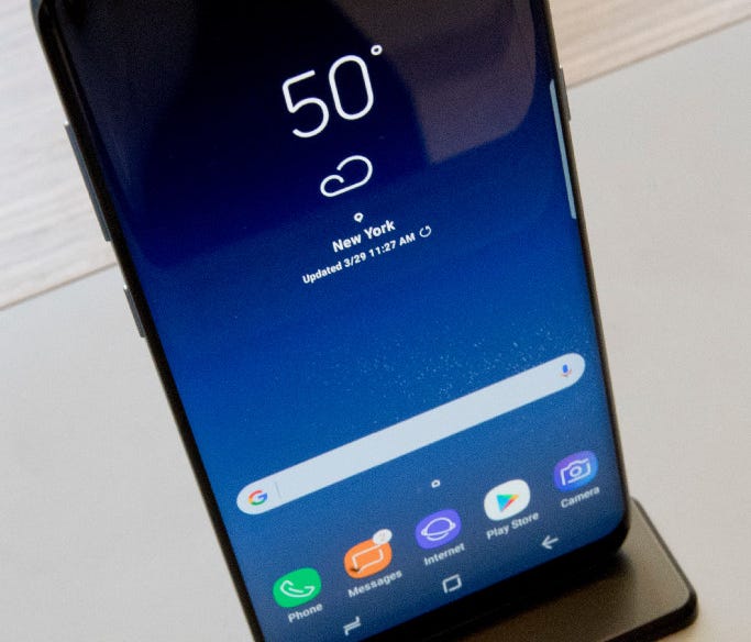 The Samsung Galaxy S8 is on display after a news conference, Wednesday, March 29, 2017, in New York. The Galaxy S8 features a larger display than its predecessor, the Galaxy S7, and sports a voice assistant intended to rival Siri and Google Assistant