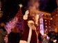 Santa Claus waves to the crowd at the lighting of the