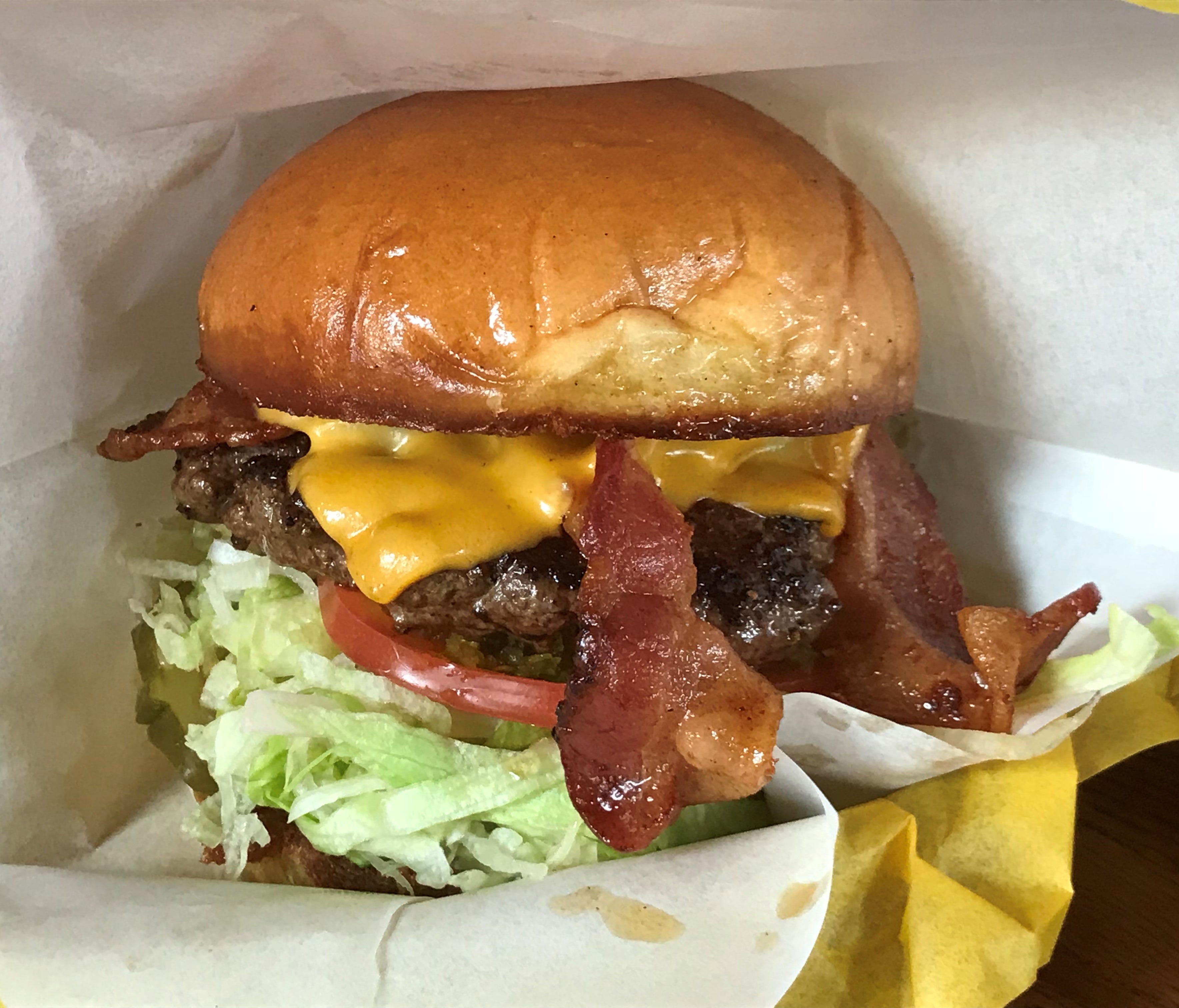 The basic bacon cheeseburger is served on a Village Baking Company roll.