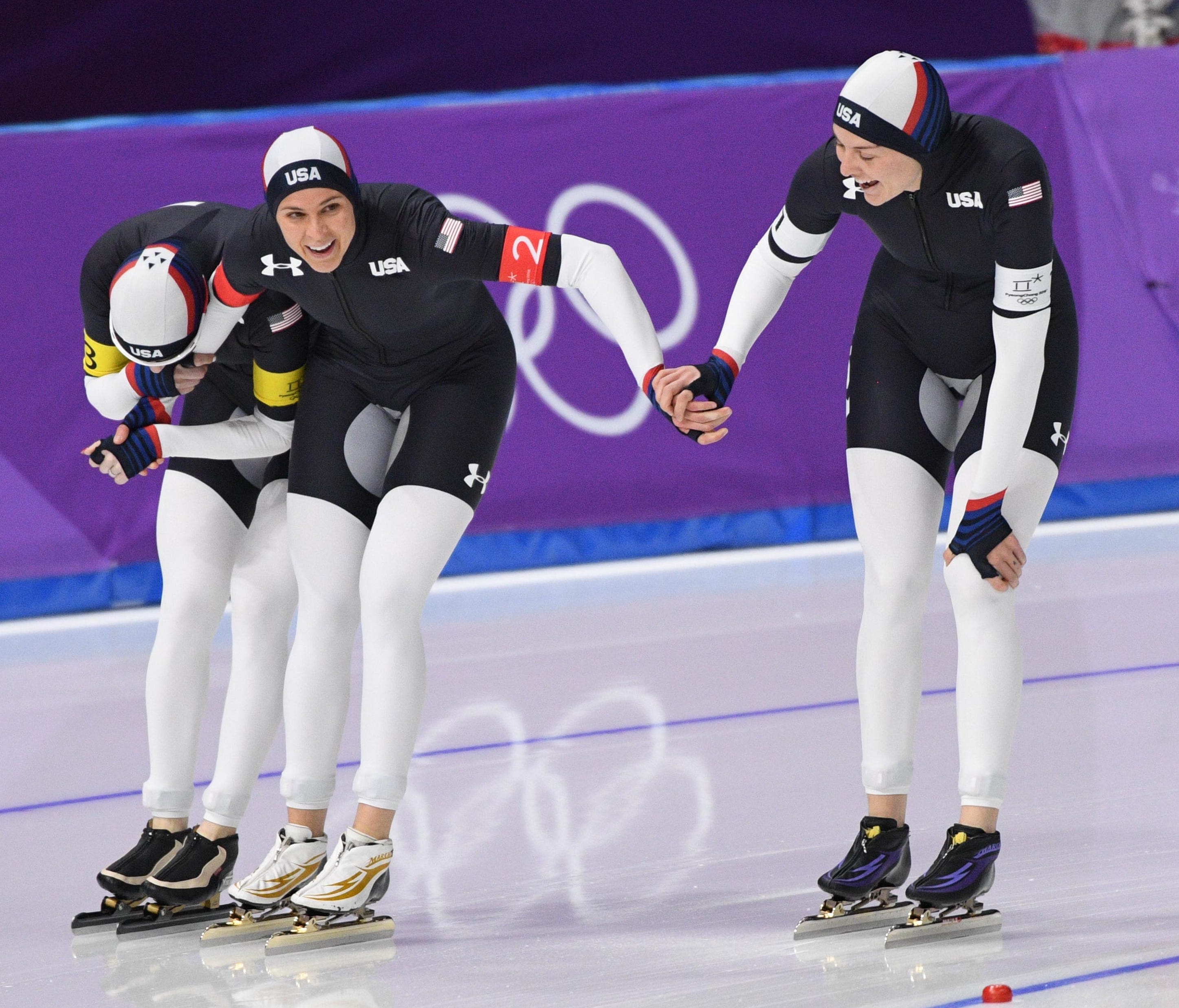 Team USA's Mia Manganello, left, Britany Bowe, center, and Heather Bergsma celebrate after winning the bronze medal in the ladies' speedskating team pursuit.