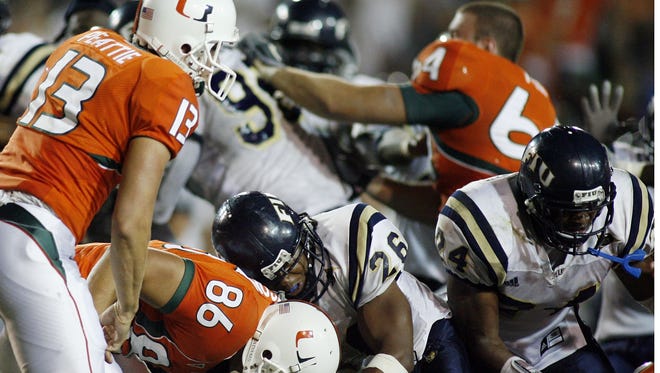 Members of the Miami Hurricanes and Florida International Panthers brawl after a game on Oct. 14, 2006.