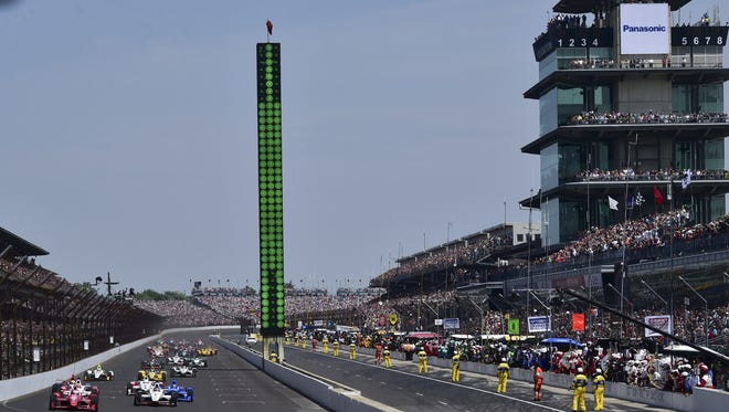 Chip Ganassi Racing driver Scott Dixon (9) takes the lead at the start as the green flag waves for The Indianapolis 500 at the Indianapolis Motor Speedway, Sunday, May 24, 2015.