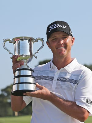 Matt Jones holds the Australian Open winner's trophy.