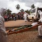 In this Wednesday, Sept. 24, 2014 file photo, healthcare workers load a man suspected of suffering from the Ebola virus onto an ambulance in Kenema, Sierra Leone.
