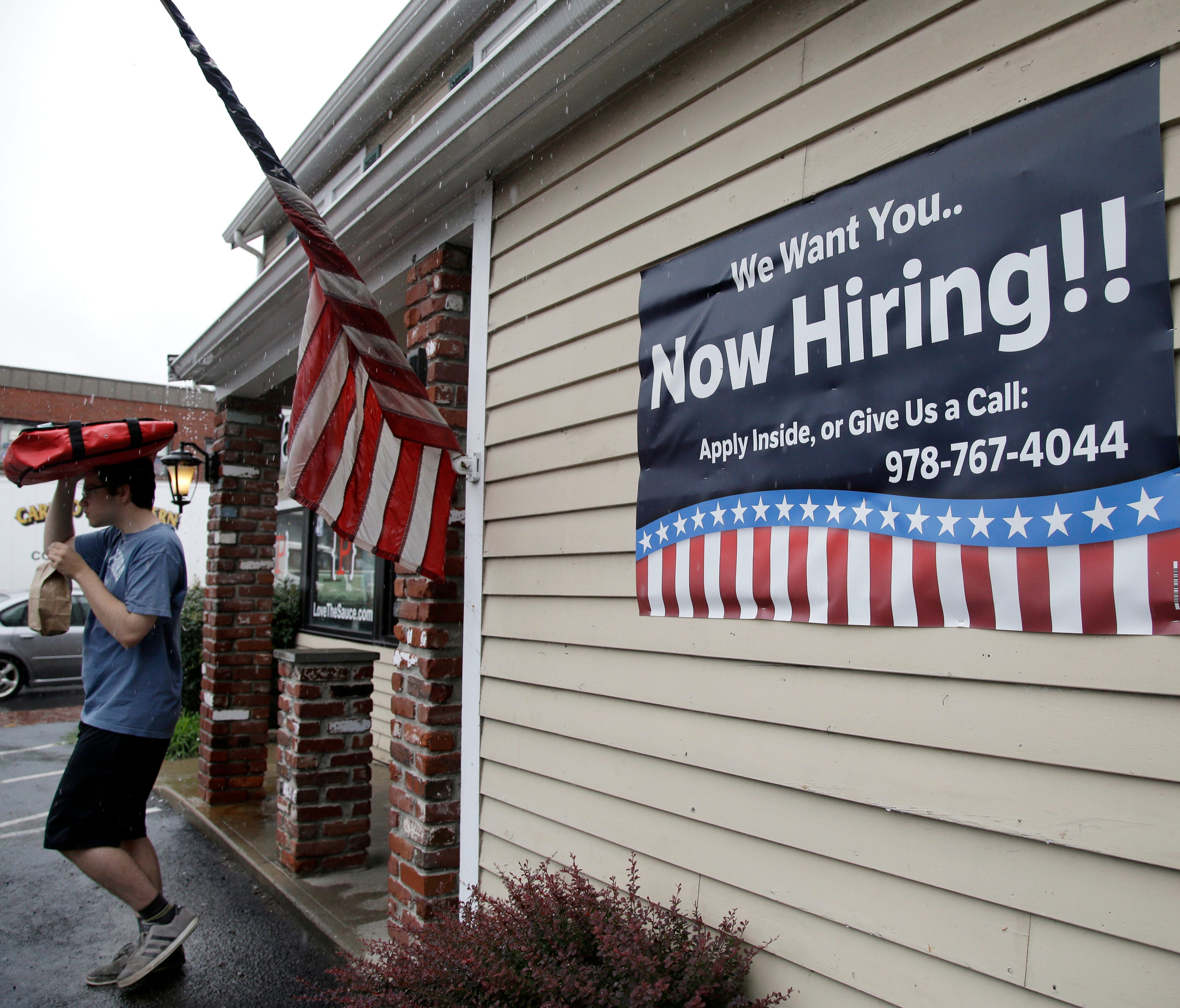 A sign advertising employment hangs outside a restaurant in Middleton, Mass. The number of Americans applying for unemployment benefits rose by 12,000 the week of Sept. 18, to 272,000 as Florida continued to absorb the economic impact of Hurricane Ir