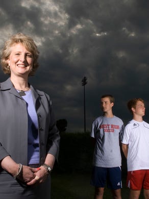 Lynne Fugate and her sons, from left, Patrick Fugate, 14, and Henley Fugate, 17 at West High School grounds.