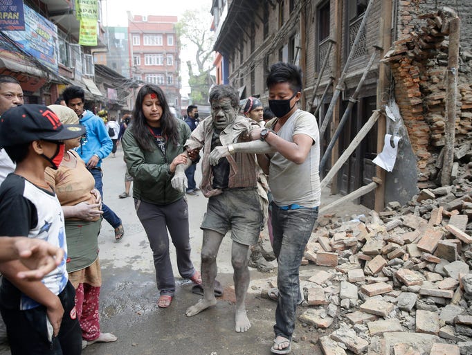 People free a man from the rubble of a destroyed building