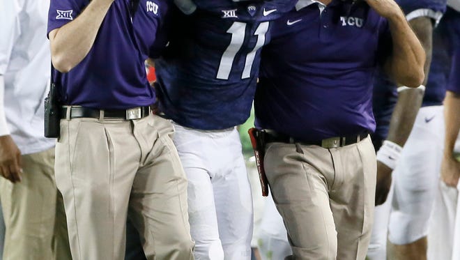 TCU cornerback Ranthony Texada (11) is helped off the field during the game against SMU.
