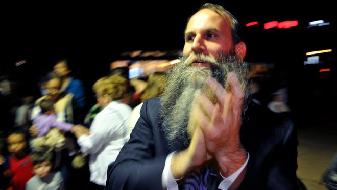 Rabbi Zvi Konikov of the Chabad of the Space & Treasure Coast in Satellite Beach enjoys the music at the Town Center in The Avenue Viera during Tuesday night's lighting of the menorah to celebrate the first day of Hanukkah.