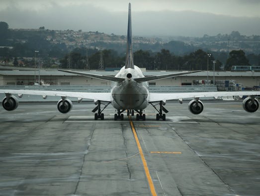 A United Airlines Boeing 747 sits on a tarmac at