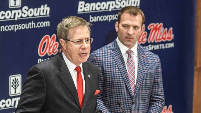 University of Mississippi chancellor Jeff Vitter, left, speaks as athletic director Ross Bjork listens as the discuss NCAA sanctions leveled against the football program during a press conference at the Manning Center in Oxford, Miss., Friday, Dec. 1, 2017. The program was handed a two-year postseason ban and other penalties by the NCAA. (Bruce Newman/The Oxford Eagle via AP)