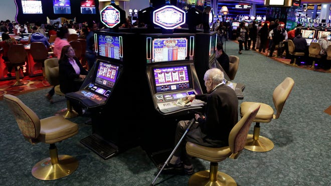 Visitors to the Resorts World Casino at the Aqueduct racetrack play electronic slot machines in the Queens borough of New York. Resorts World was one of the racinos in the state that had positive growth last year.