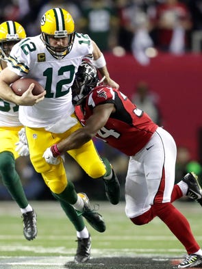 Green Bay Packers quarterback Aaron Rodgers (12) scrambles