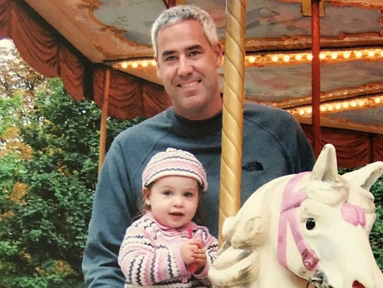 Greg Shamus holds his daughter, Julia, 18 months, on