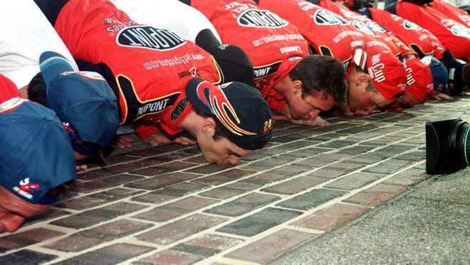 Jeff Gordon and crew kiss the bricks after winning the 2001 Brickyard 400 at the Indianapolis Motor Speedway.