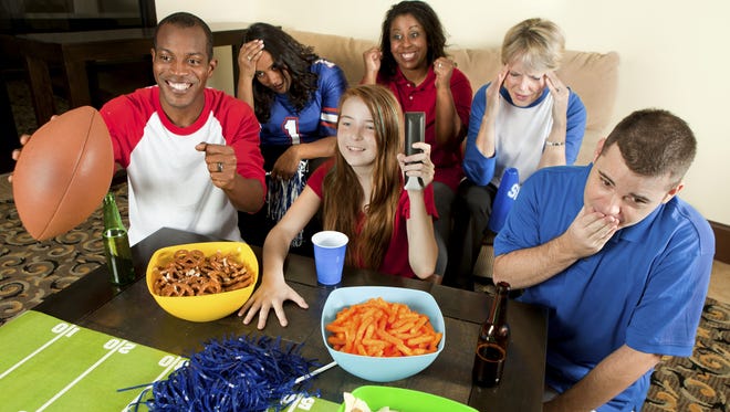Diverse Group of Family and Friends Watching a Football Game