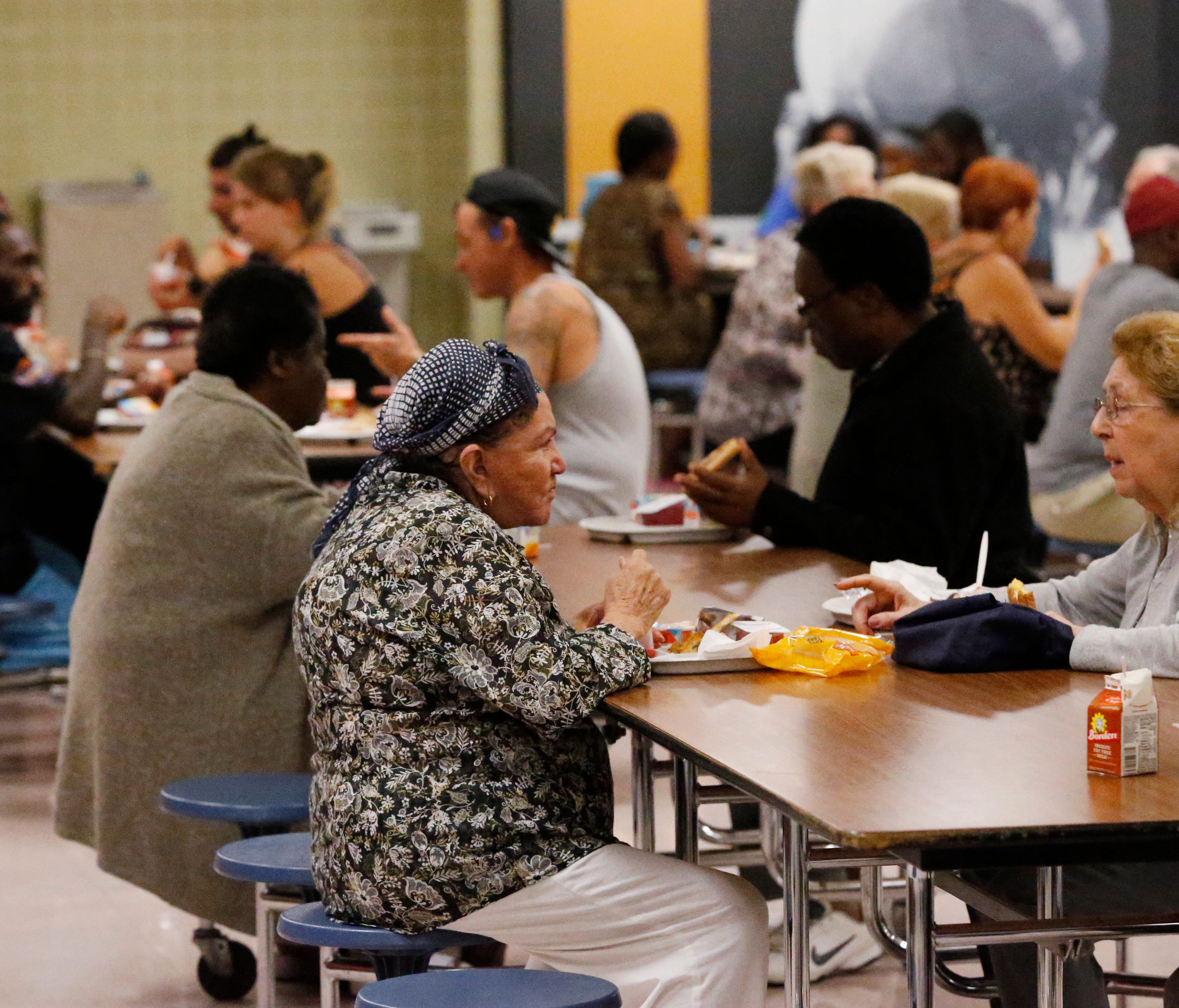 People at a Red Cross shelter set up at North Miami Beach Senior High School eat lunch. Airbnb is trying to find housing for evacuees.