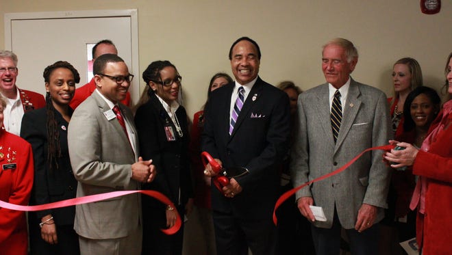 David Hunt cuts a ribbon to open Lane College's new business center Monday.