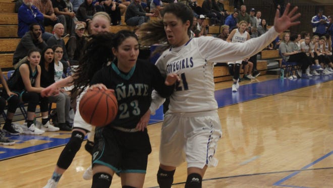 Carlsbad senior point guard Mariel Gomez blocks Onate near the hoop during Tuesday's contest against the Lady Knights in Carlsbad.