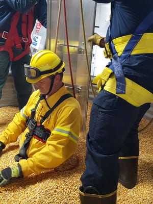 A flowing column of grain in a bin will pull a person down to knee level in 15 seconds and completely bury him or her in 30 seconds. Viroqua Fire Department members are pictured training on using a grain bin rescue device.
