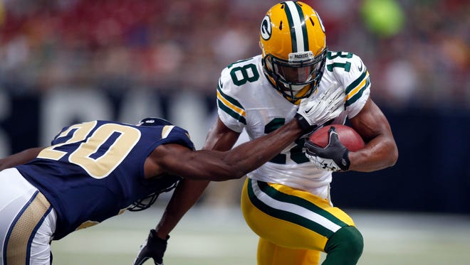 Green Bay Packers wide receiver Randall Cobb, right, runs with the ball after catching a pass for a 9-yard gain as St. Louis Rams cornerback Lamarcus Joyner defends during the first quarter of an NFL preseason football game Saturday, Aug. 16, 2014, in St. Louis. (AP Photo/Scott Kane)