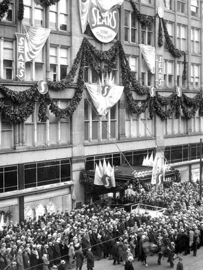 A crowd gathers for the grand opening of a Sears store