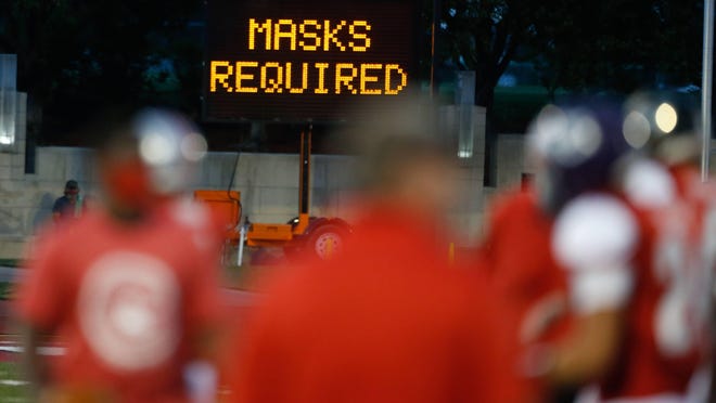 A sign reminds patrons that mask were required Saturday for the Shrine Bowl at Hummer Sports Park.